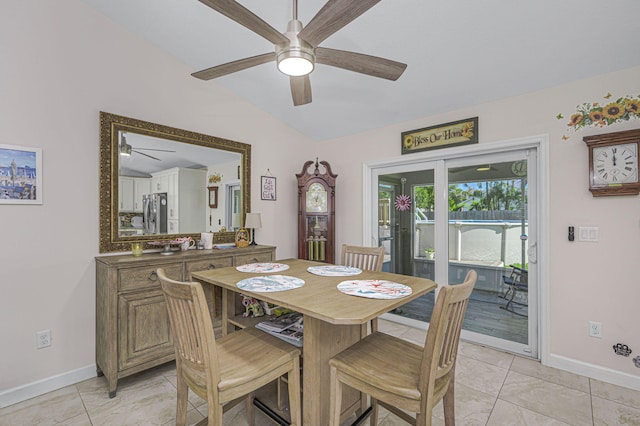 tiled dining area featuring vaulted ceiling and ceiling fan