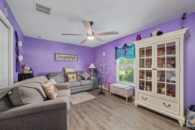 living room featuring hardwood / wood-style floors and ceiling fan