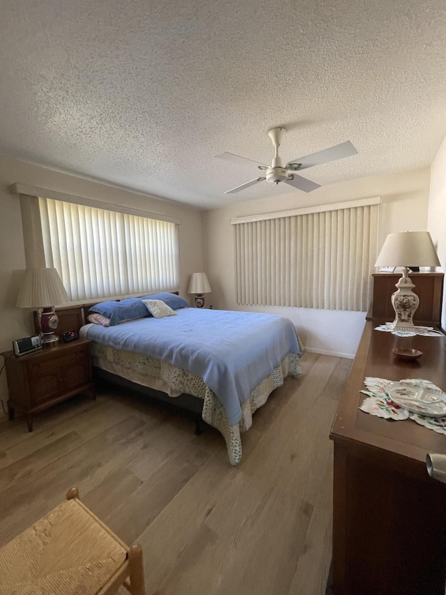 bedroom featuring ceiling fan, a textured ceiling, and hardwood / wood-style flooring