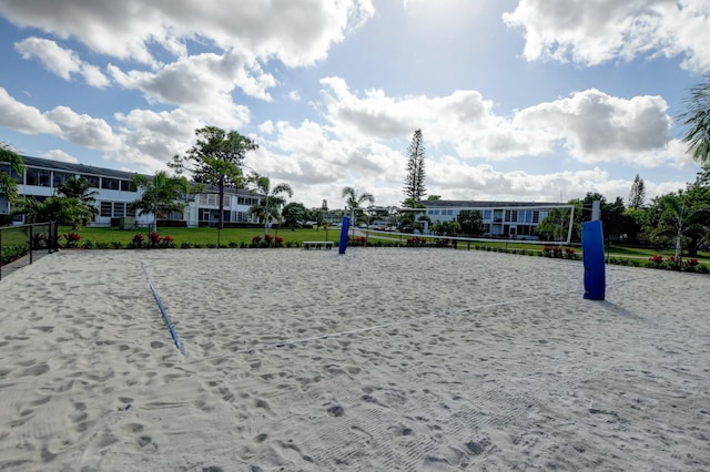 view of property's community featuring volleyball court and a yard