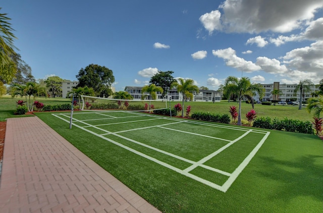 view of community with a yard and volleyball court