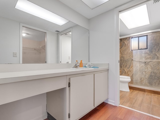 bathroom featuring hardwood / wood-style floors, vanity, and toilet