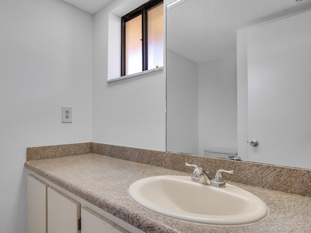 bathroom with vanity and toilet