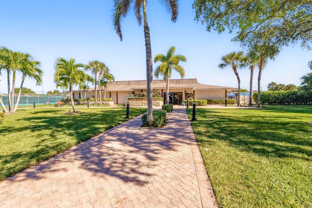 surrounding community with a lawn and a water view