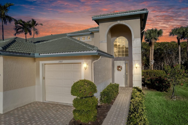 mediterranean / spanish home featuring a garage