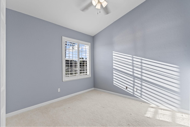 carpeted spare room with vaulted ceiling and ceiling fan