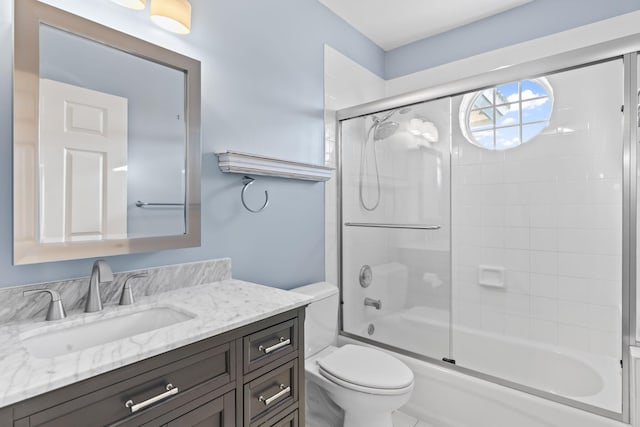 full bathroom with vanity, toilet, and bath / shower combo with glass door