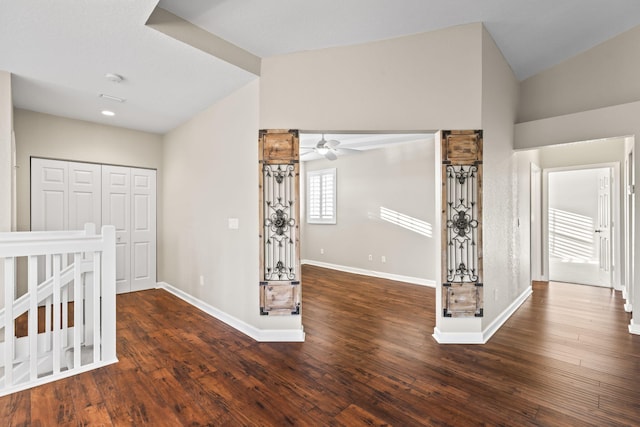 unfurnished bedroom with vaulted ceiling and dark wood-type flooring