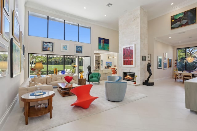 tiled living room with crown molding, a fireplace, and a towering ceiling