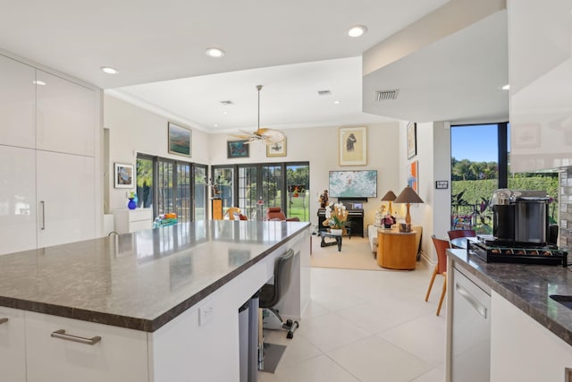 kitchen with white cabinets, white dishwasher, ceiling fan, and crown molding