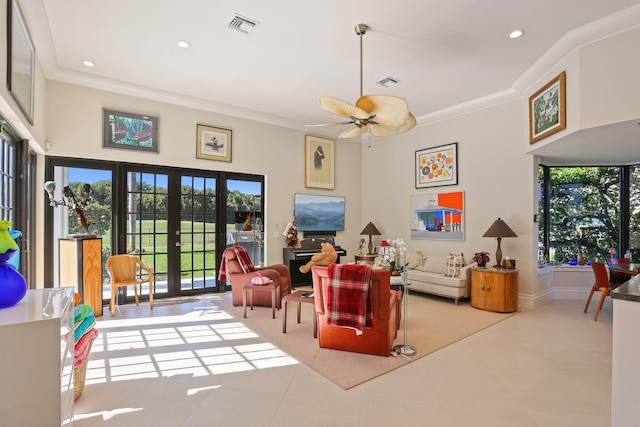 living room with french doors, ceiling fan, and crown molding