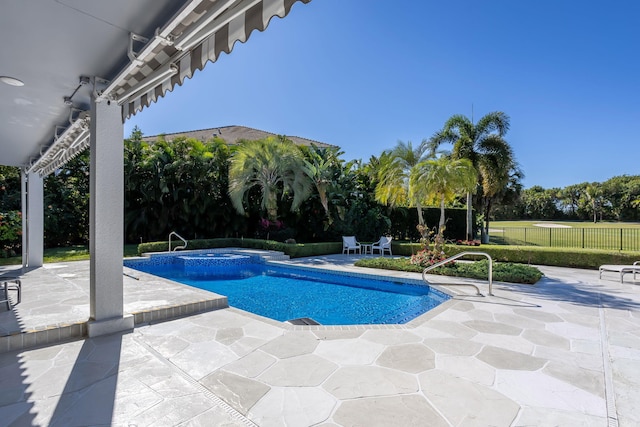 view of swimming pool featuring a patio area and an in ground hot tub