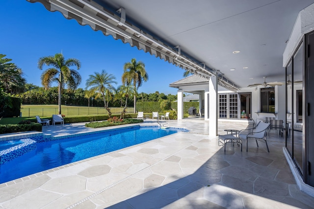 view of swimming pool featuring a patio area, ceiling fan, and a jacuzzi