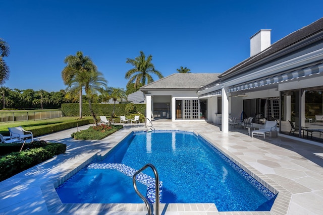 view of swimming pool featuring ceiling fan and a patio area