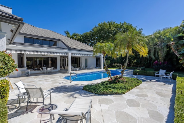 view of swimming pool with a patio