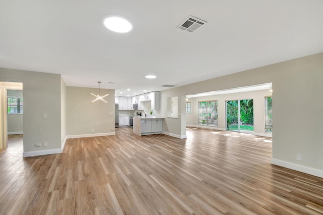 unfurnished living room featuring light wood-type flooring