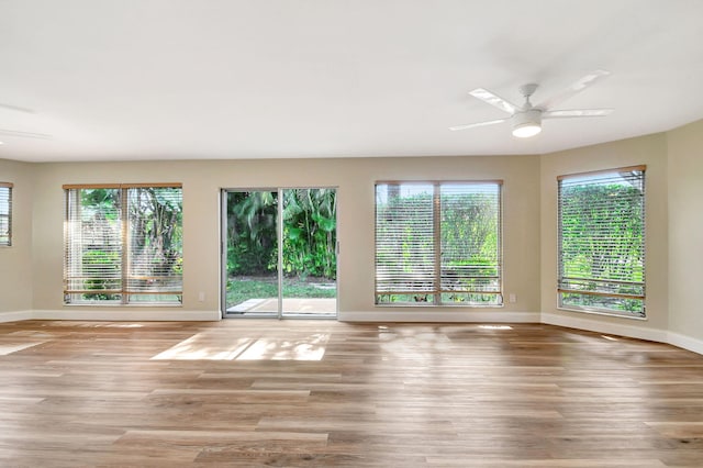 spare room with ceiling fan and light wood-type flooring