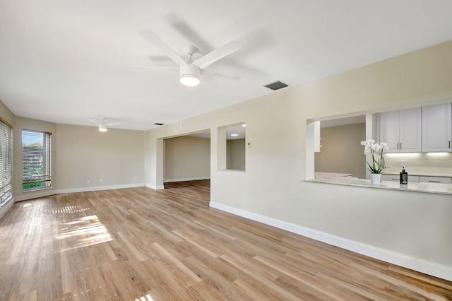 spare room featuring ceiling fan and light hardwood / wood-style flooring