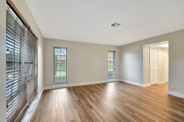 empty room with light hardwood / wood-style floors