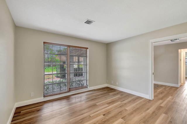 unfurnished room featuring light hardwood / wood-style floors