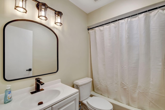 full bathroom featuring vanity, shower / bath combo, and toilet