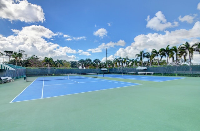 view of tennis court featuring basketball hoop