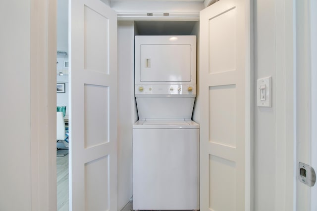 laundry room with stacked washing maching and dryer