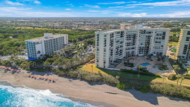 drone / aerial view featuring a beach view and a water view