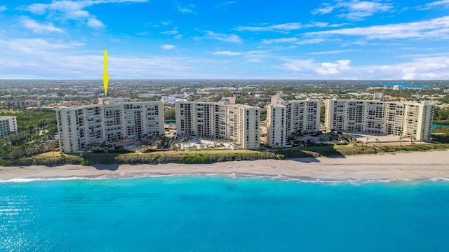 drone / aerial view featuring a view of the beach and a water view