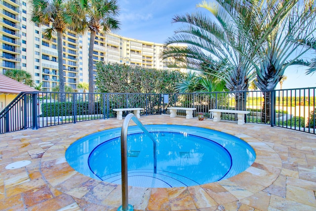 view of pool with a hot tub