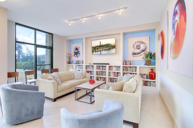 living room with expansive windows and light tile patterned floors