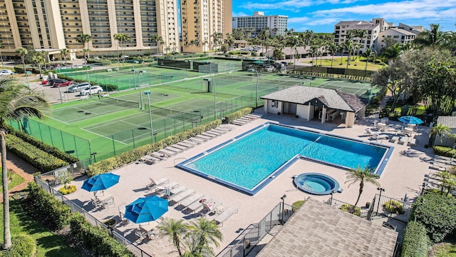 view of swimming pool featuring tennis court