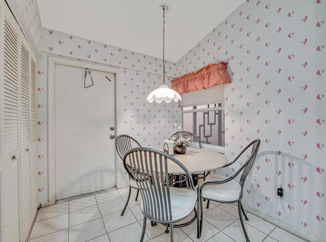 dining area with light tile patterned flooring and lofted ceiling