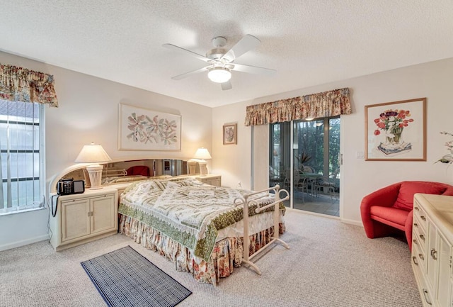 bedroom with access to exterior, ceiling fan, light colored carpet, and a textured ceiling