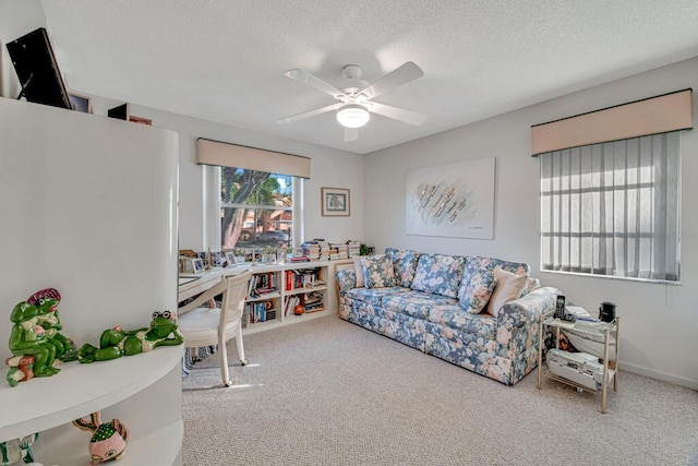 carpeted living room featuring a textured ceiling and ceiling fan