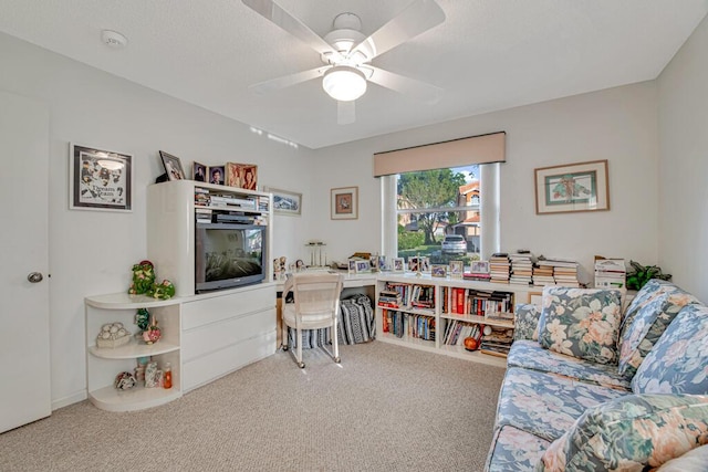 carpeted office featuring ceiling fan