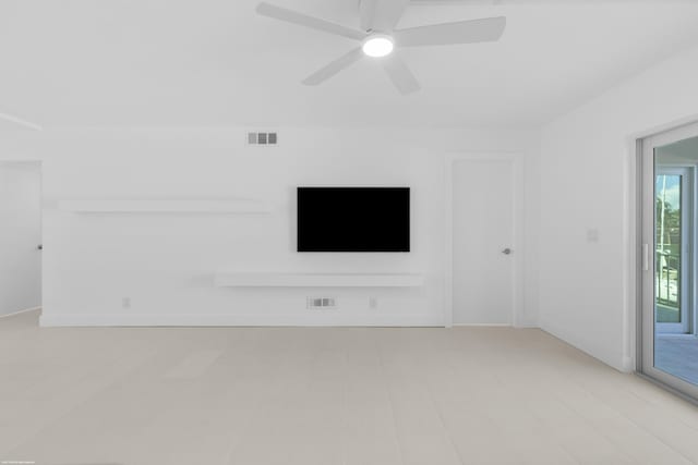 unfurnished living room featuring ceiling fan