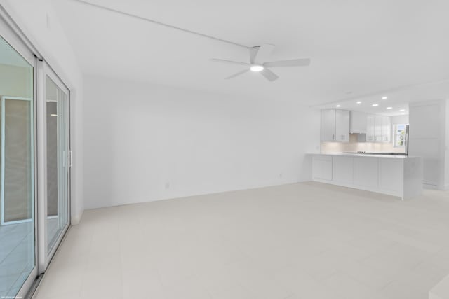 unfurnished living room featuring ceiling fan