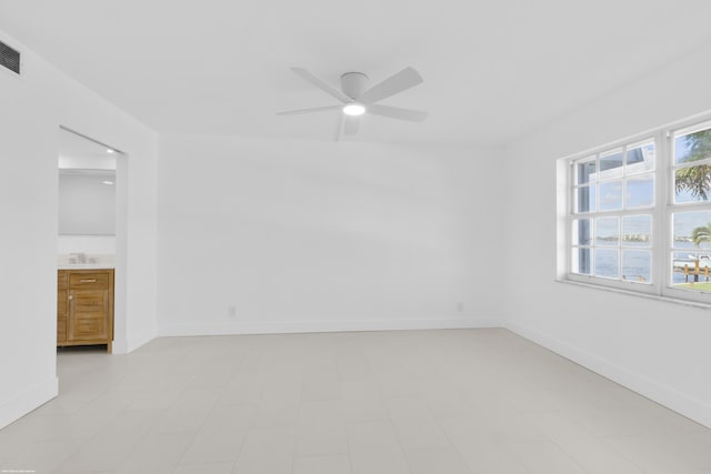 unfurnished room with ceiling fan