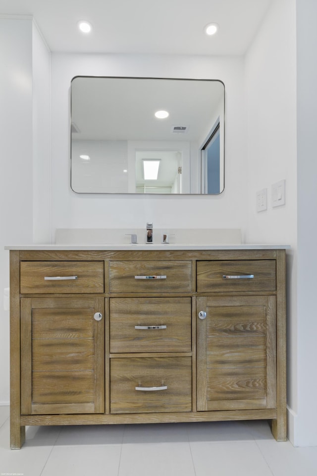 bathroom with tile patterned flooring and vanity