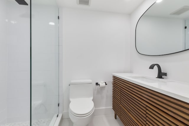 bathroom featuring tile patterned flooring, vanity, toilet, and walk in shower