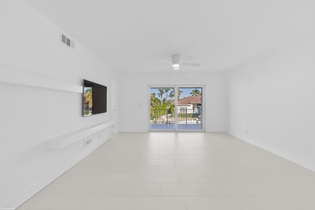 unfurnished living room featuring ceiling fan and light tile patterned floors