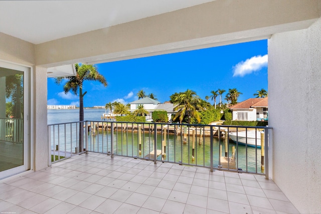 view of patio / terrace featuring a water view and a balcony