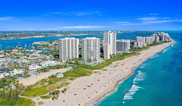 drone / aerial view with a water view and a beach view