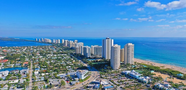 birds eye view of property with a water view and a beach view