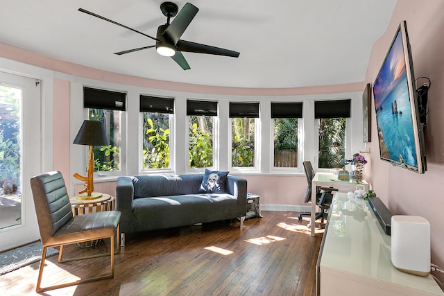 living room with ceiling fan and dark hardwood / wood-style flooring