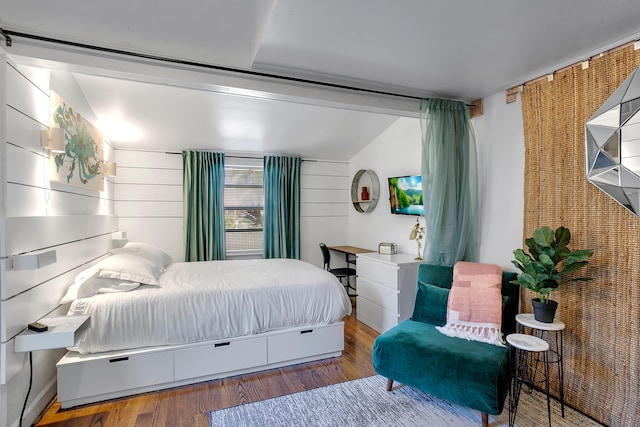 bedroom featuring hardwood / wood-style flooring and vaulted ceiling