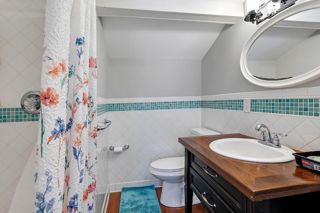 bathroom featuring hardwood / wood-style floors, curtained shower, tile walls, vanity, and toilet