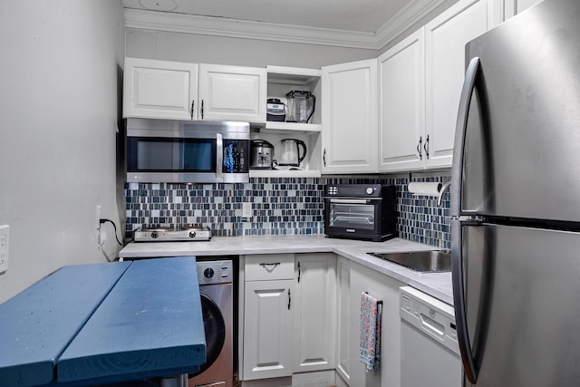 kitchen with washer / clothes dryer, white cabinetry, appliances with stainless steel finishes, and backsplash