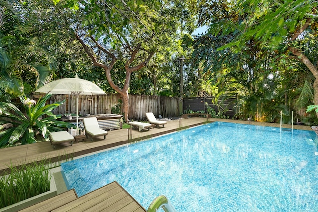 view of swimming pool featuring a wooden deck